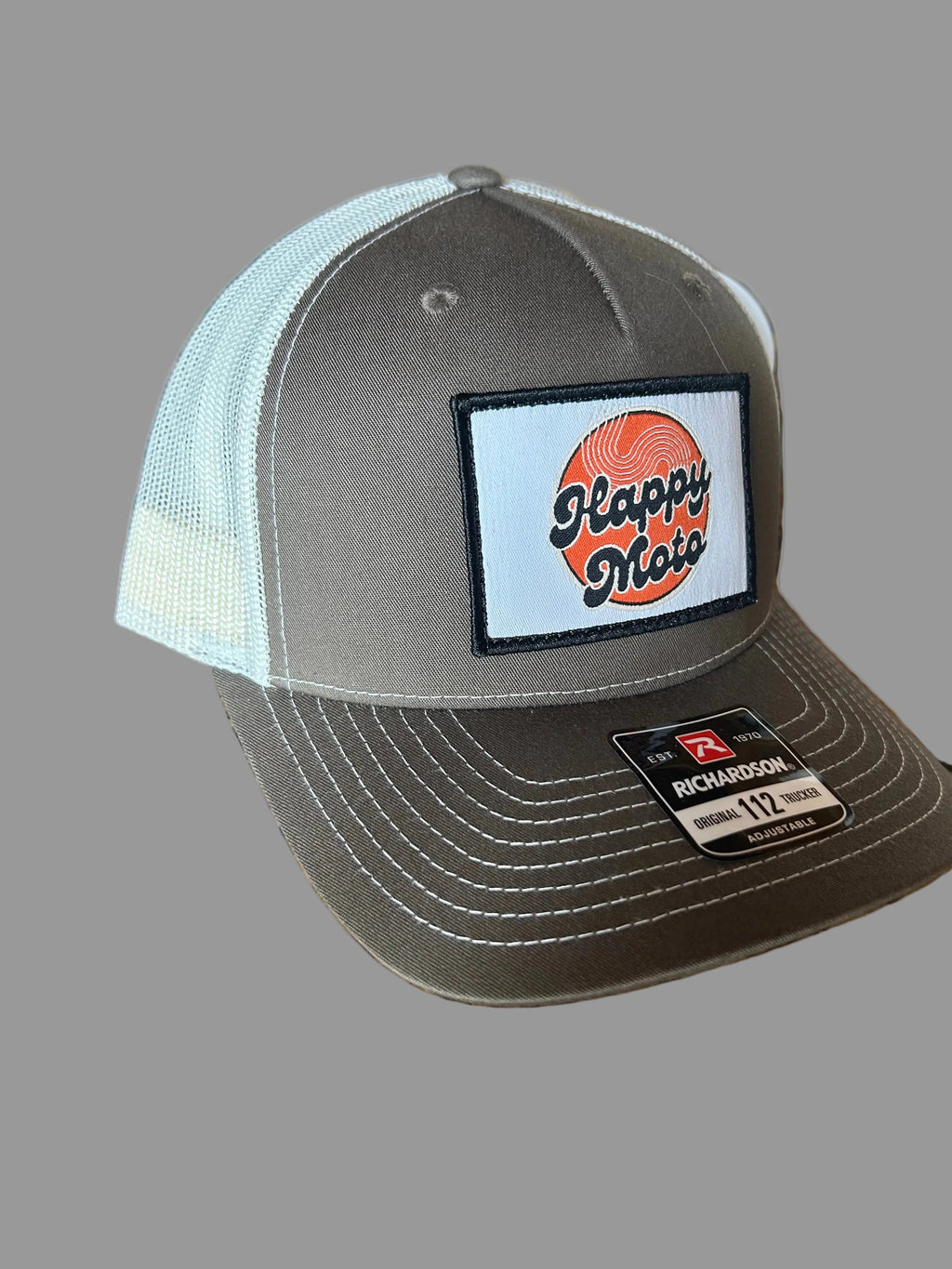 Gray trucker cap with a patch and Richardson logo on a gray background